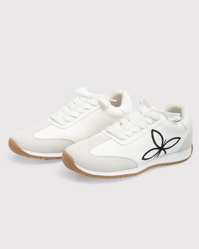 Zapatillas blancas con bordado floral contrastante